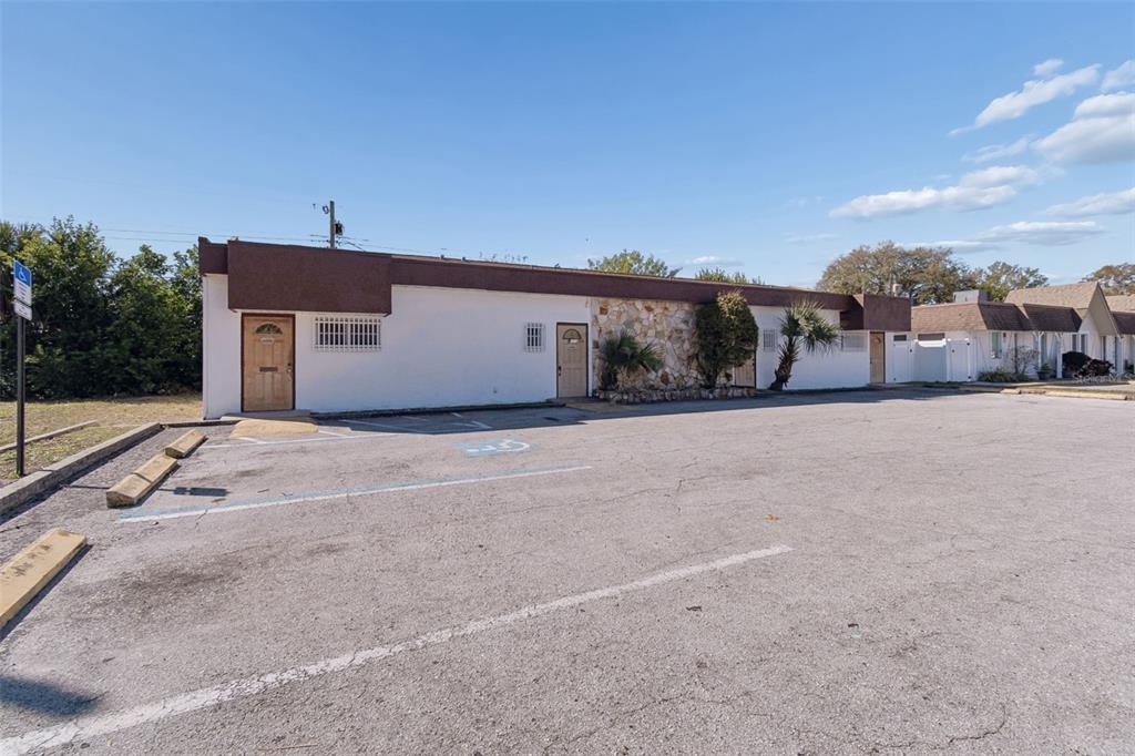 A single-story commercial building with a stone facade and a paved parking lot in front — 1152 62ND AVENUE S, ST PETERSBURG, FL
