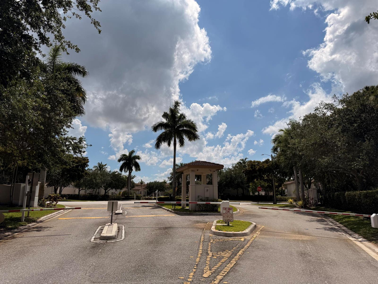 A gated community entrance features a guardhouse, palm trees, and a blue sky — 2512 NW 4th Street, Boynton Beach FL 33426, BOYNTON BEACH, FL