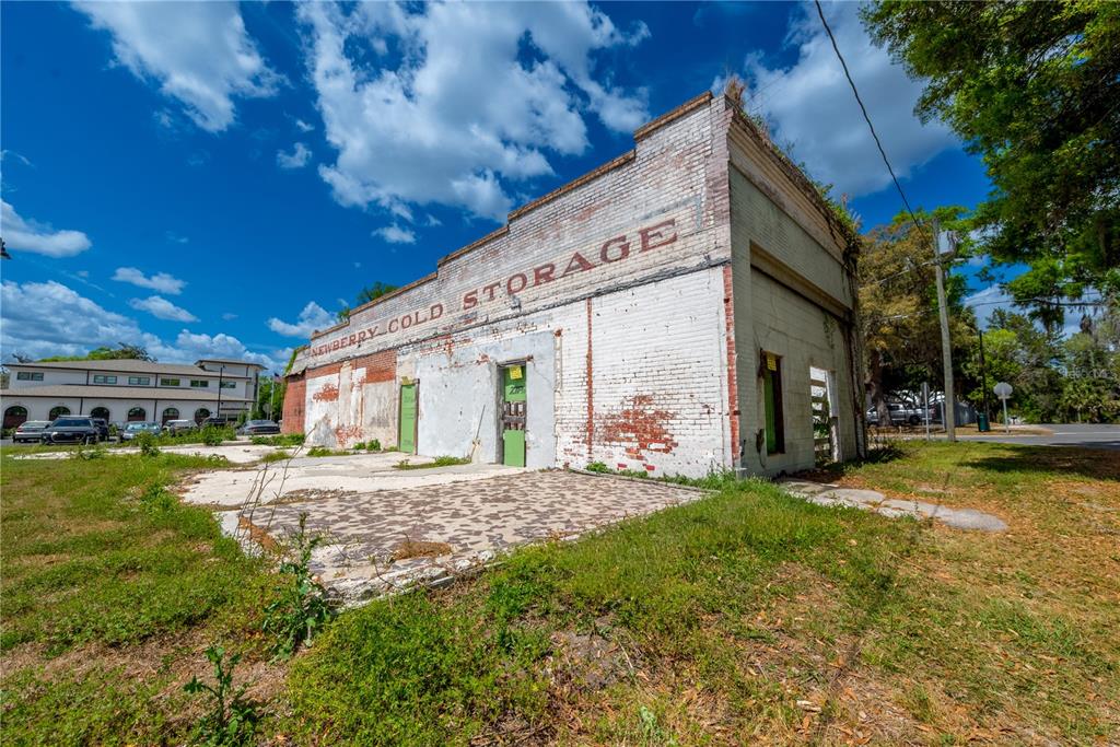 An exterior view of a weathered, single-story brick building labeled Newberry Cold Storage — 98 NW 254TH STREET, NEWBERRY, FL