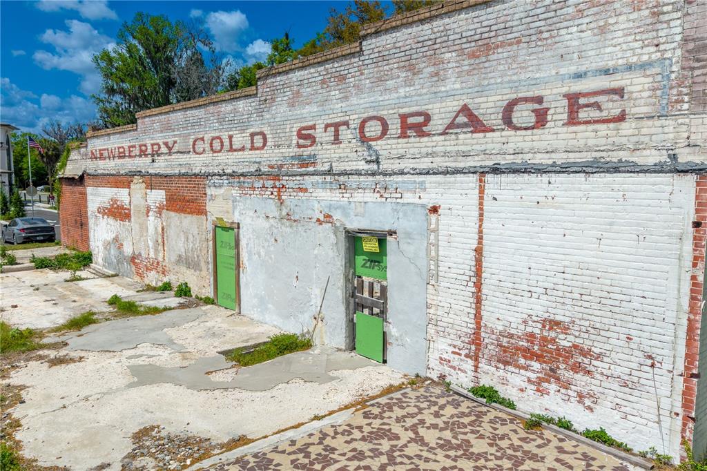 An exterior view of a weathered brick building with faded signage reading Newberry Cold Storage — 98 NW 254TH STREET, NEWBERRY, FL