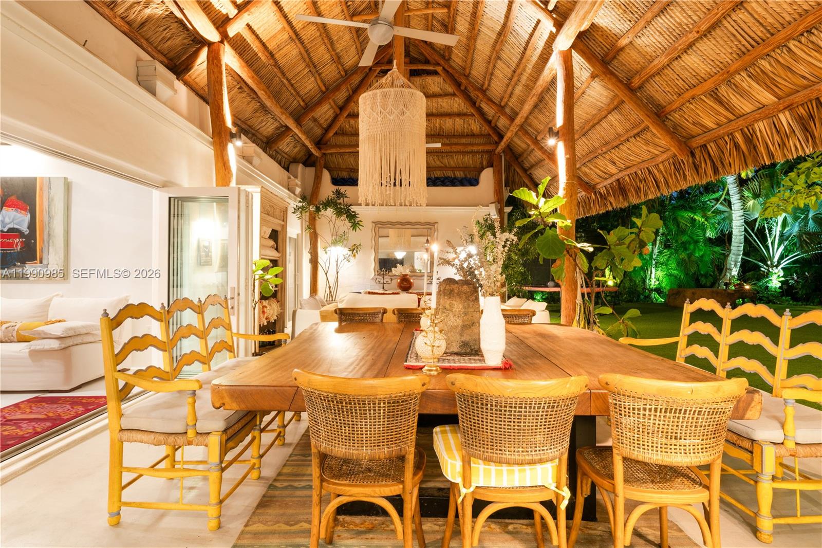 An outdoor dining area features a large wooden table under a thatched roof — 330 Gulf Rd, Key Biscayne FL 33149, KEY BISCAYNE, FL