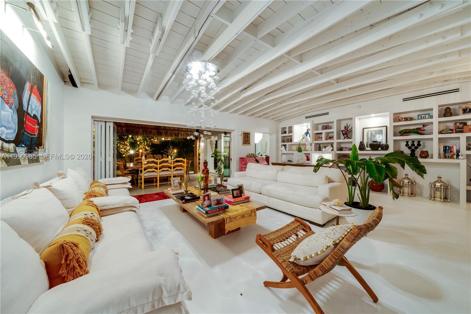 A white-walled living room features a beamed ceiling, a large coffee table, and open shelving — 330 Gulf Rd, Key Biscayne FL 33149, KEY BISCAYNE, FL