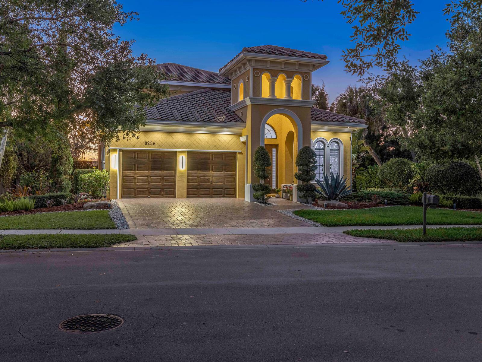 A two-story Mediterranean-style house with a tile roof, arched entryway, and a two-car garage — 8256 Bradford Way, Parkland FL 33076, PARKLAND, FL