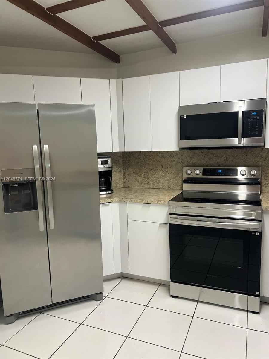 A kitchen features white cabinets, stainless steel appliances, and a speckled countertop — 10241 NW 9th St Cir # 5, Miami FL 33172, MIAMI, FL