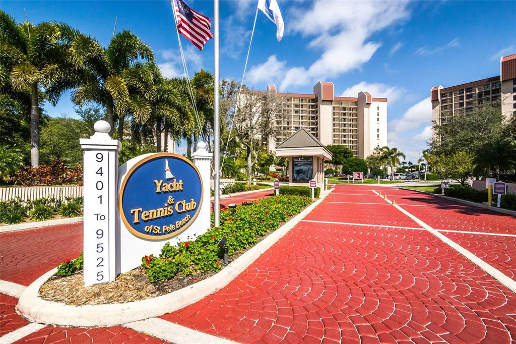 The entrance to the Yacht & Tennis Club of St. Pete Beach features a sign — 9495 BLIND PASS ROAD UNIT 205, ST PETE BEACH, FL
