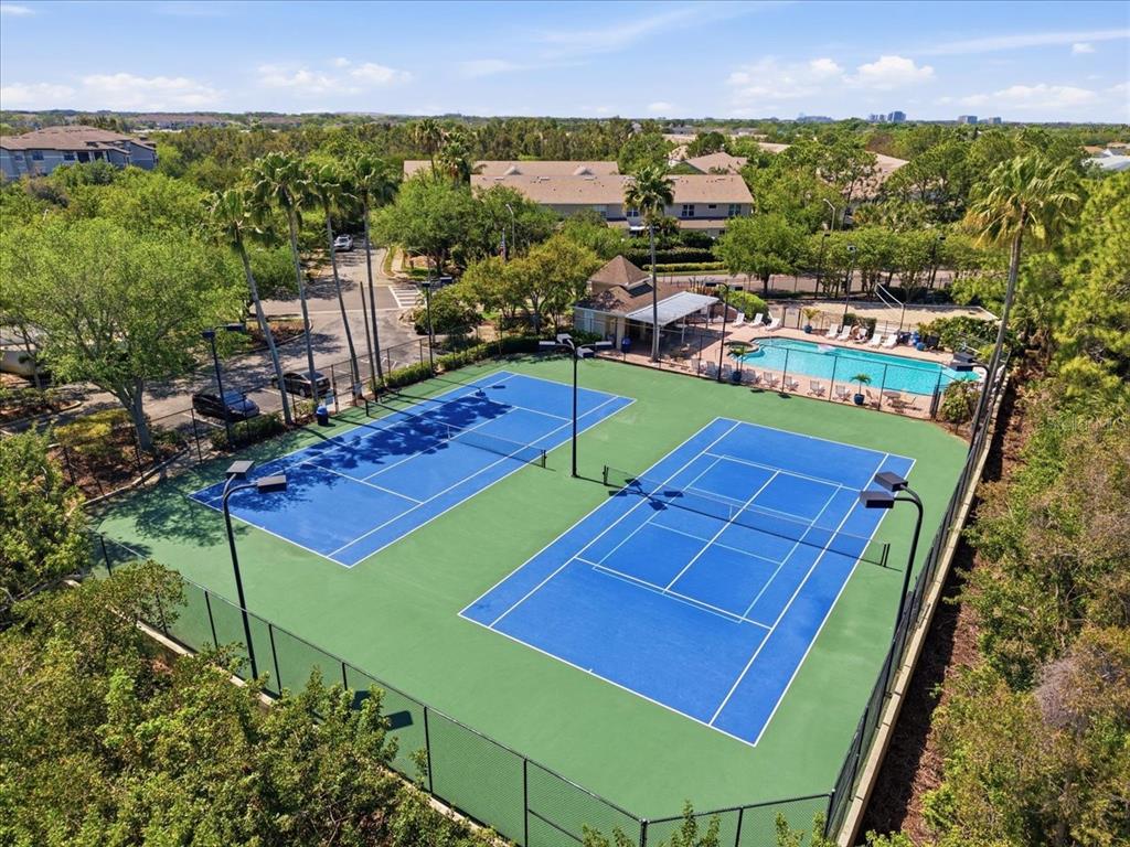 An aerial view shows a multi-unit townhouse building with attached garages and surrounding landscaping — 752 VALLANCE WAY NE, ST PETERSBURG, FL