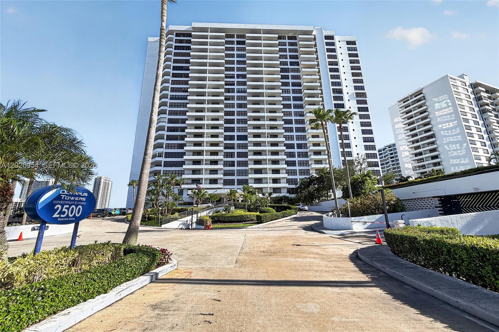A tall residential high-rise building features multiple balconies and a landscaped entrance driveway — 2500 Parkview Dr # 1717, Hallandale Beach FL 33009, HALLANDALE BEACH, FL