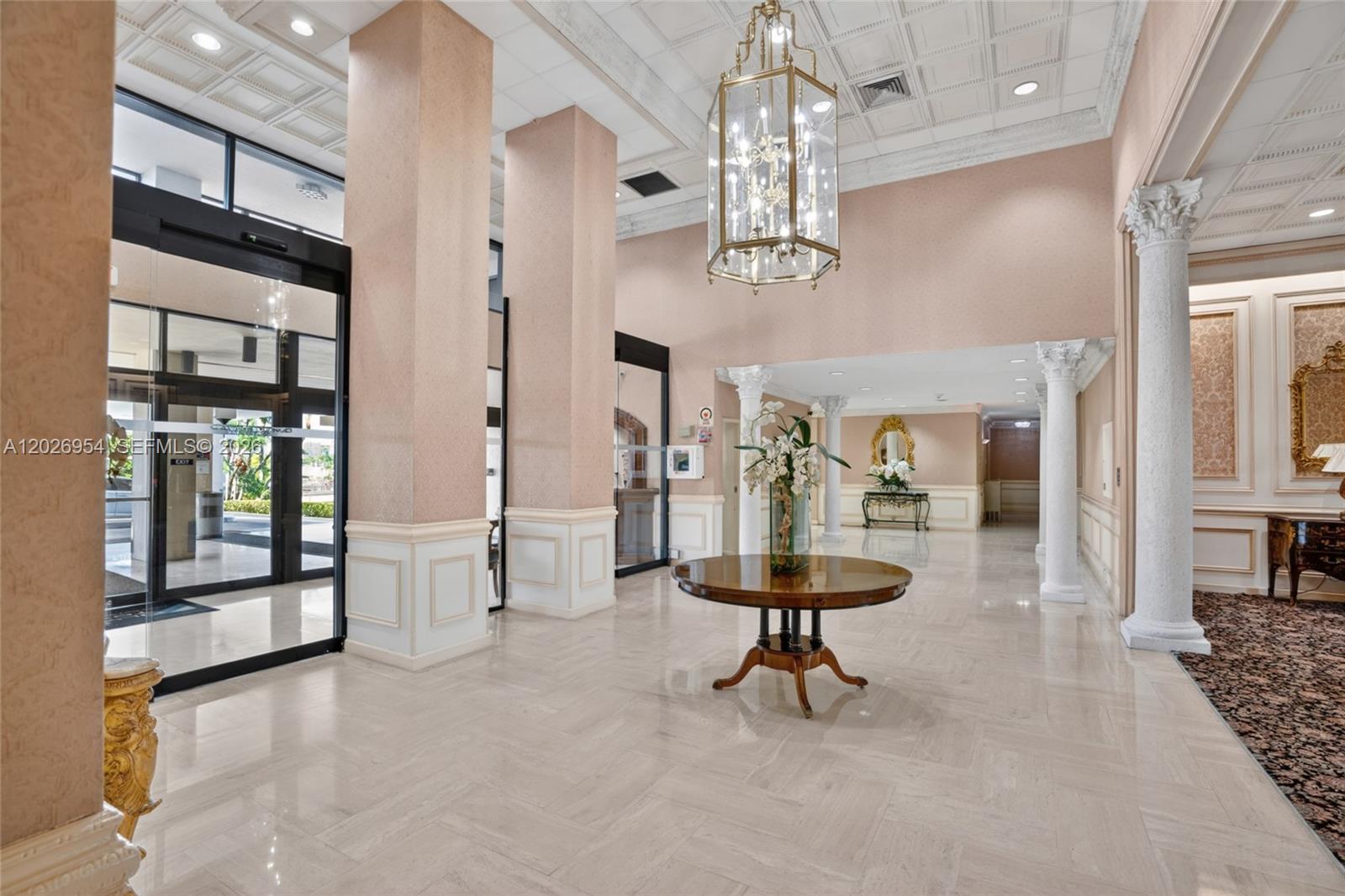 A spacious lobby features a coffered ceiling, marble floors, decorative columns, and a central table — 2500 Parkview Dr # 1717, Hallandale Beach FL 33009, HALLANDALE BEACH, FL