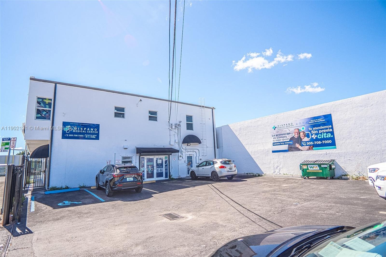 A two-story white medical center building with a parking lot and a large wall sign — 3401 NW 7th St, Miami FL 33125, MIAMI, FL