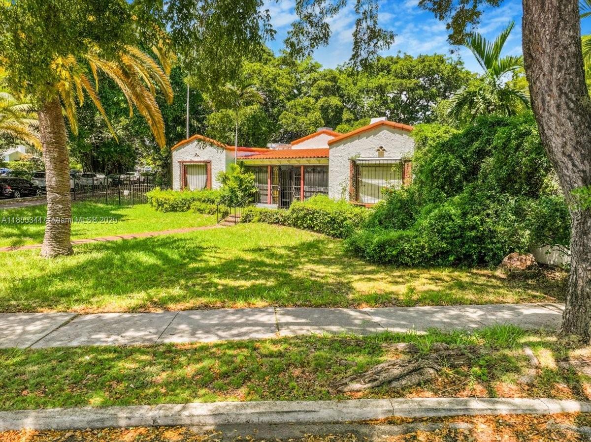 A single-story house with a red tile roof sits behind a grassy front yard — 5900 NE 5th Ave, Miami FL 33137, MIAMI, FL