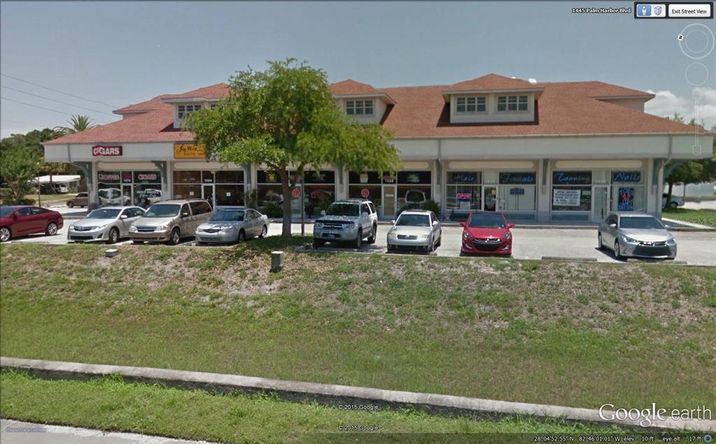 A single-story commercial strip mall with a red roof and several parked cars in front — 1454-1470 ALT 19 UNIT 1454-1470, PALM HARBOR, FL