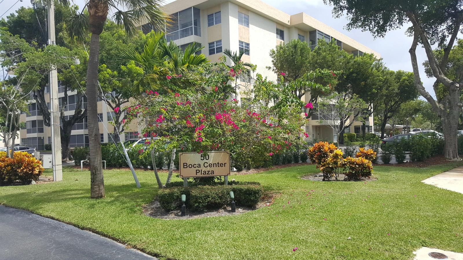 A sign for Boca Center Plaza stands on a grassy lawn in front of apartment buildings — 50 SW 3rd Avenue # 5080, Boca Raton FL 33432, BOCA RATON, FL