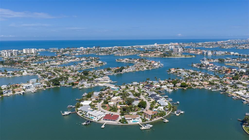 An aerial view of residential homes situated on islands surrounded by a large bay — 735 79TH CIRCLE S, ST PETERSBURG, FL