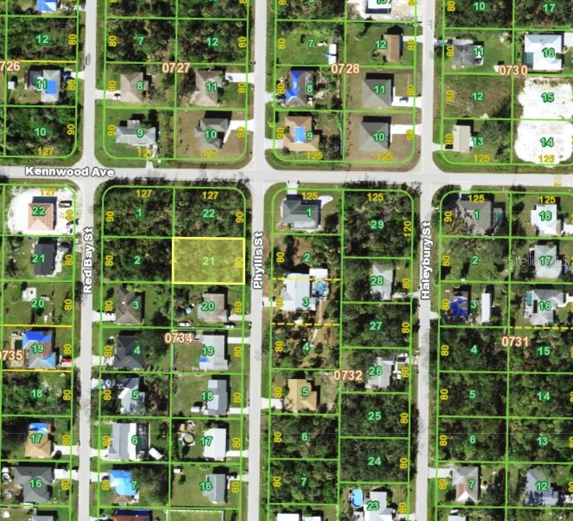 This is a satellite map showing a vacant residential lot highlighted in yellow — 1071 KENNWOOD AVENUE, PORT CHARLOTTE, FL