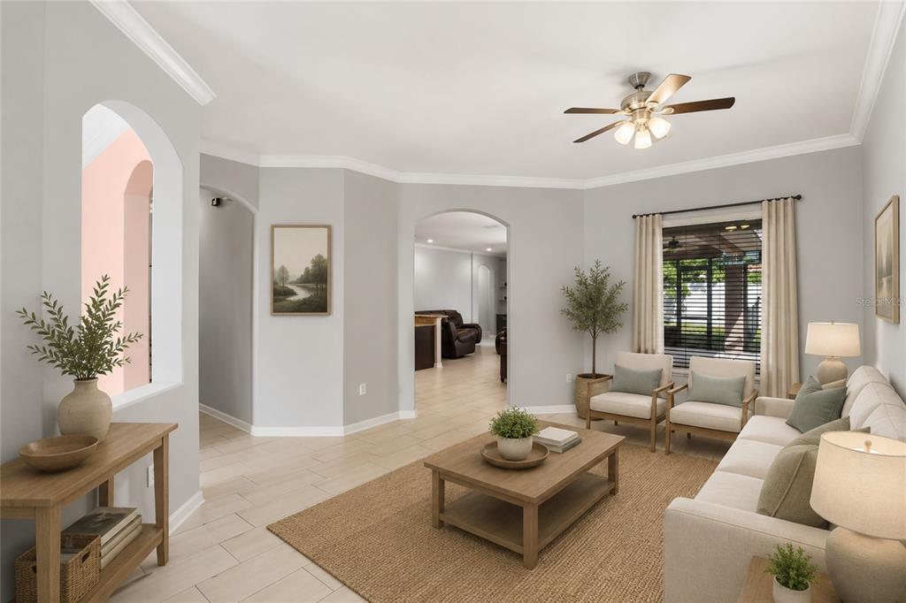 A living room with light gray walls, a ceiling fan, and a neutral-toned area rug — 410 SAUVIGNON WAY, GROVELAND, FL