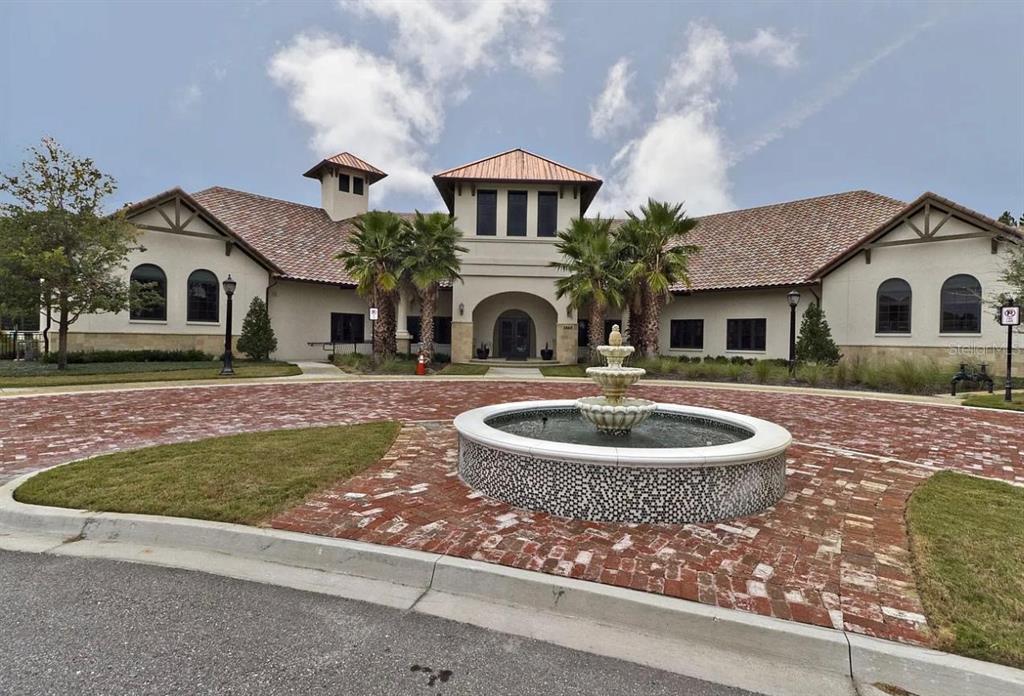 A multi-story building with a tiled roof and a circular fountain in the front courtyard — 36 PRIVADO COURT UNIT 36, ST AUGUSTINE, FL