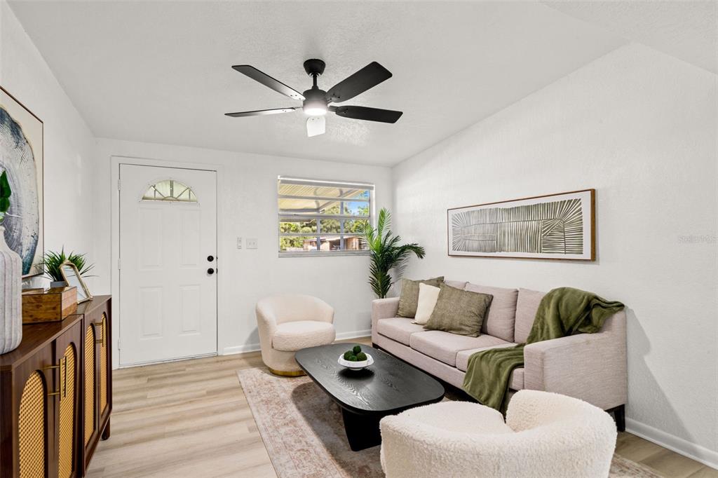 A living room features a sofa, two armchairs, a coffee table, and a ceiling fan — 4914 S 82ND STREET, TAMPA, FL