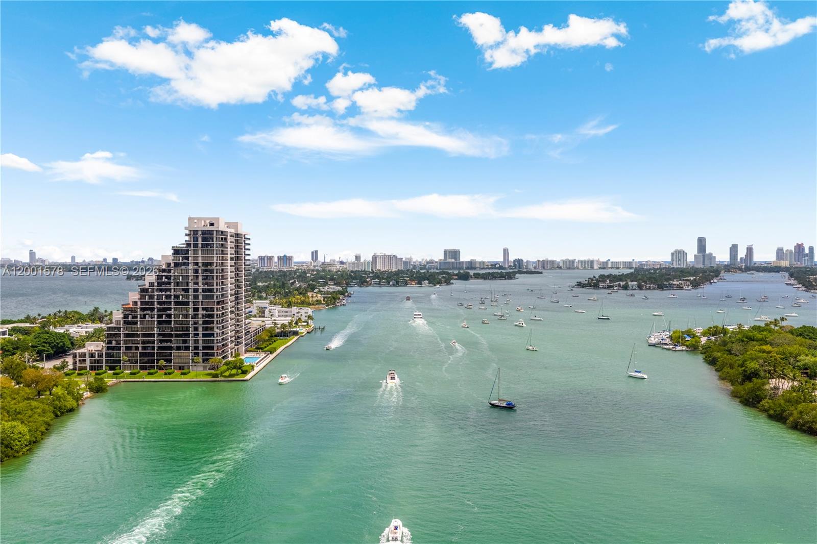 An aerial view shows a high-rise building beside a waterway filled with boats — 1000 Venetian Way # 408, Miami FL 33139, MIAMI, FL