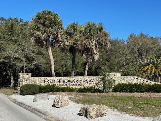 An exterior view of a multi-story apartment building with concrete stairs leading to an entrance — 514 WINDRUSH BAY DRIVE UNIT 514, TARPON SPRINGS, FL