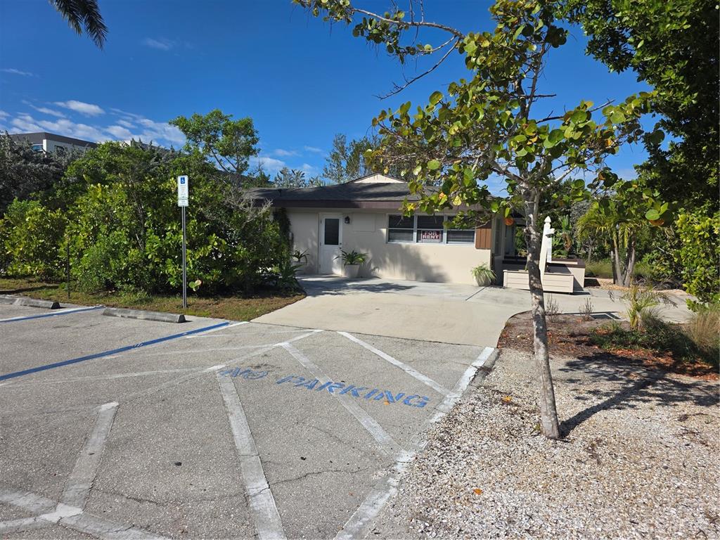 A single-story building with a concrete driveway and a marked handicap parking space — 725 PATTY AVENUE, PUNTA GORDA, FL