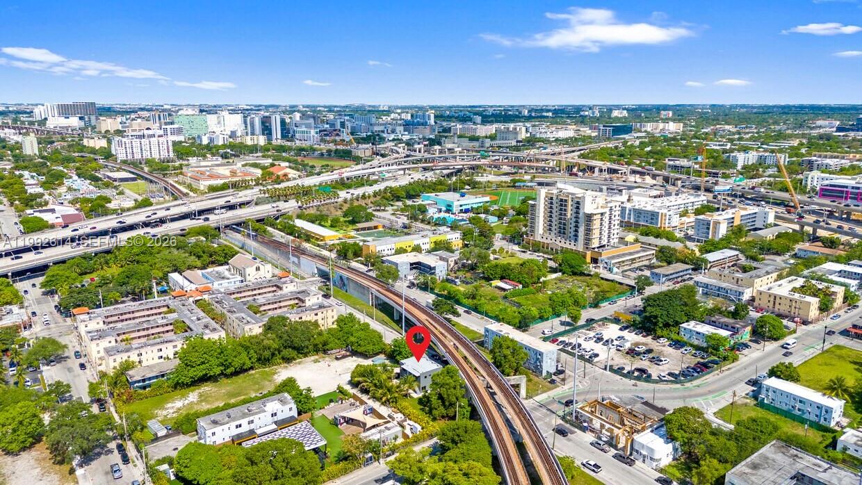 Aerial view of a small building marked with a red pin near an elevated railway — 216 NW 11th St, Miami FL 33136, MIAMI, FL