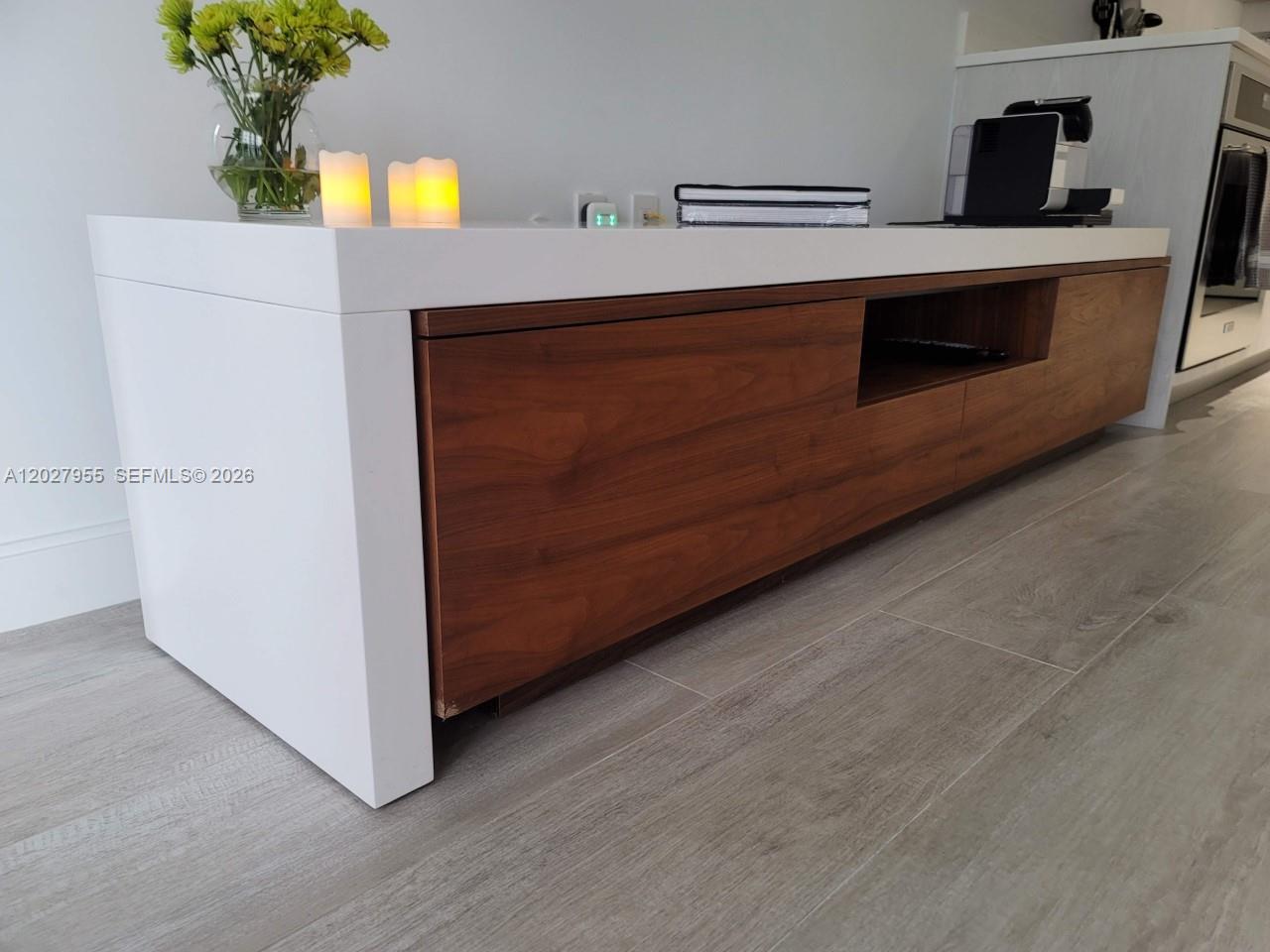 A modern white and wood media console sits on a light wood-look floor — 55 SW 9th St # 2709, Miami FL 33130, MIAMI, FL