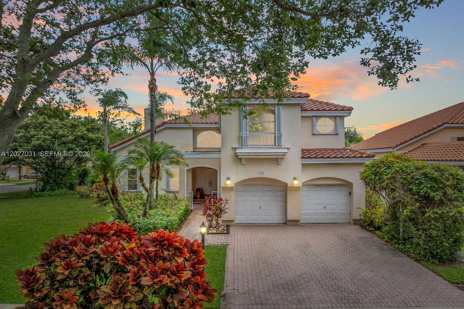 A two-story stucco house with a tile roof, two-car garage, and a paved driveway — 3990 Lansing Ave, Cooper City FL 33026, COOPER CITY, FL