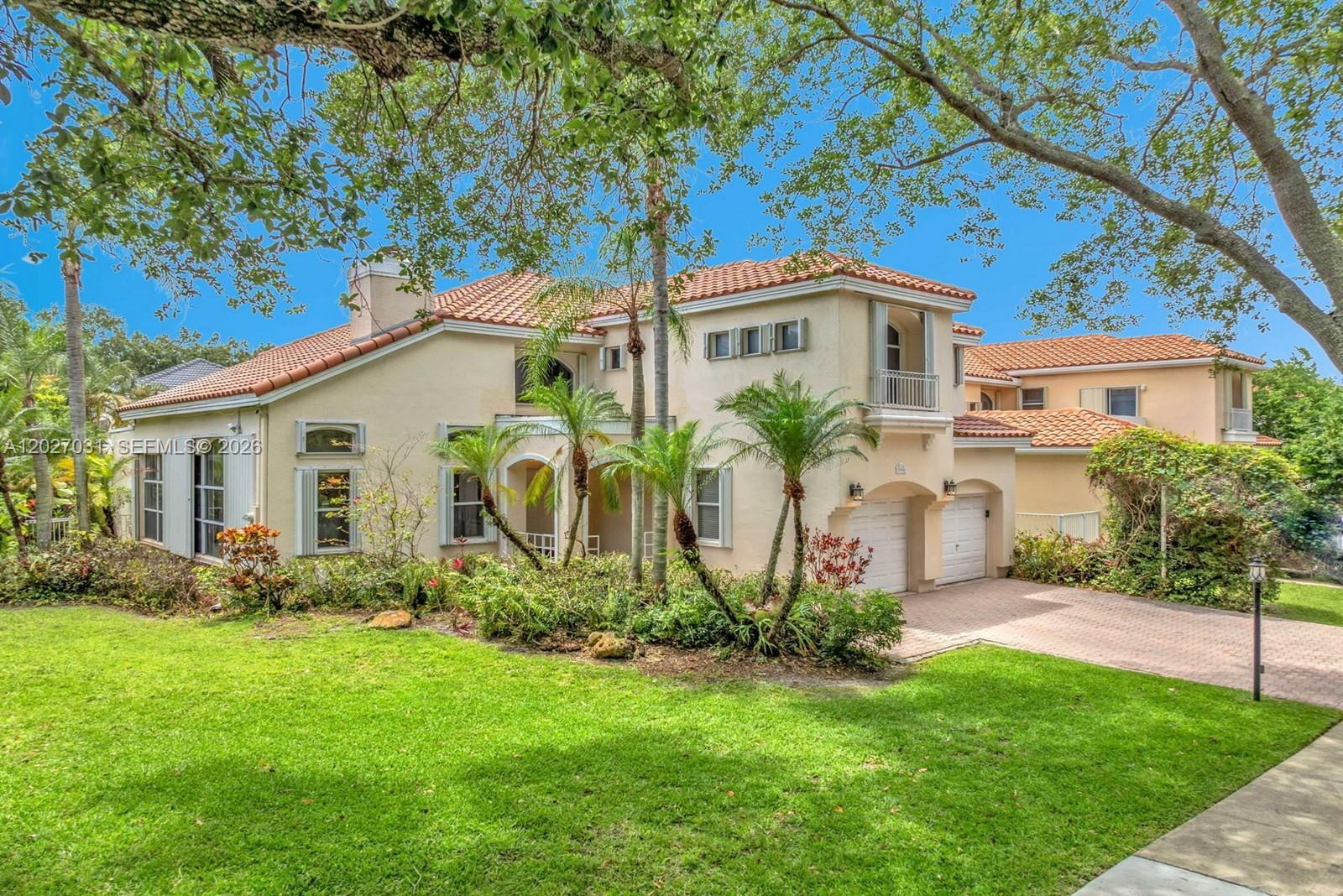 A two-story stucco house with a tile roof, two-car garage, and landscaped front yard — 3990 Lansing Ave, Cooper City FL 33026, COOPER CITY, FL