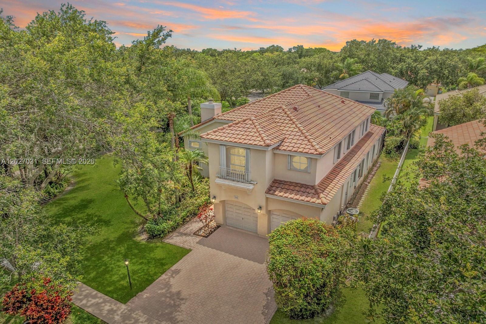An aerial view of a two-story beige house with a tiled roof and driveway — 3990 Lansing Ave, Cooper City FL 33026, COOPER CITY, FL