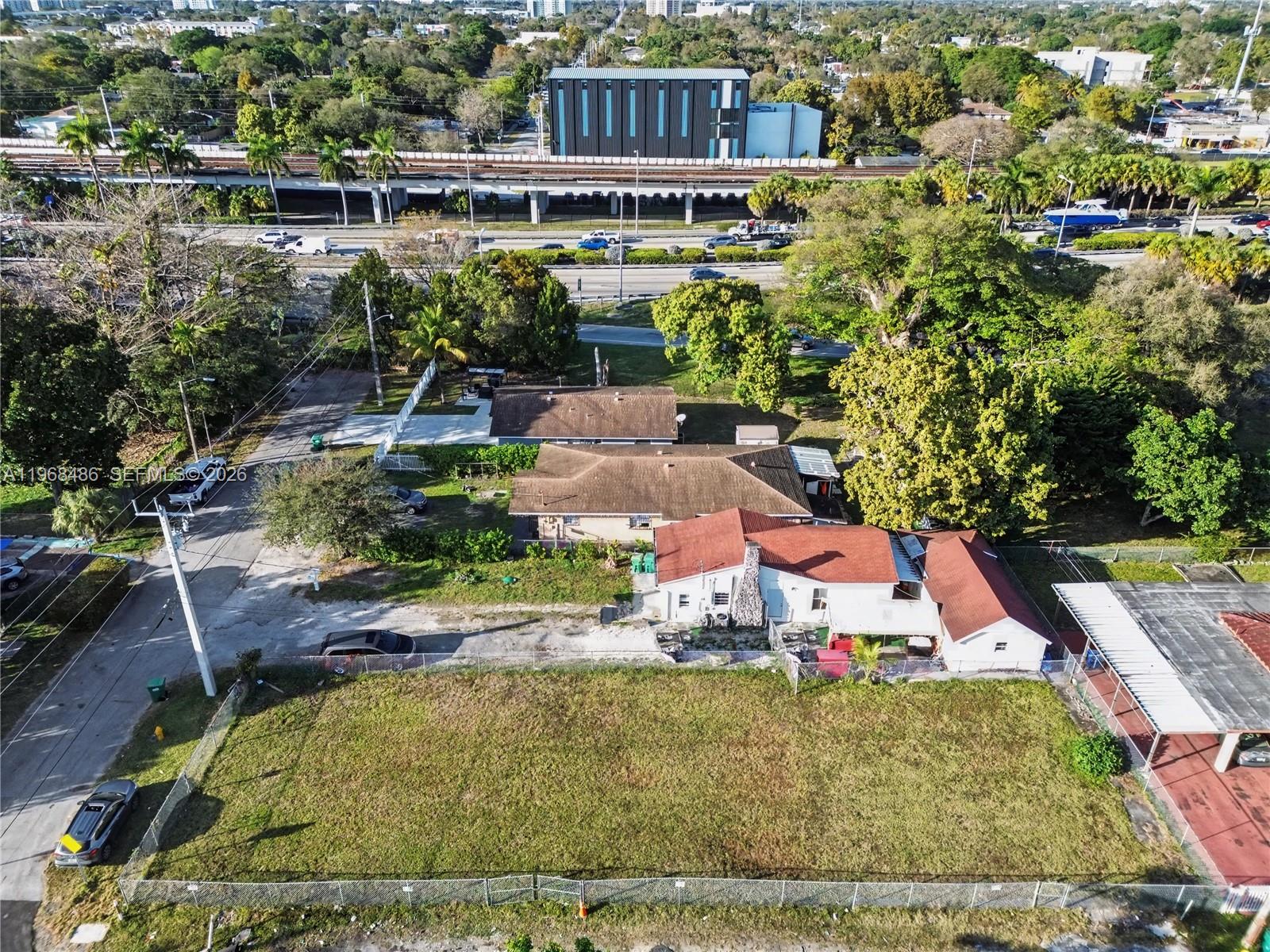 An aerial view shows a residential property with a large yard and adjacent buildings — 3801 NW 23rd Ave, Miami FL 33142, MIAMI, FL