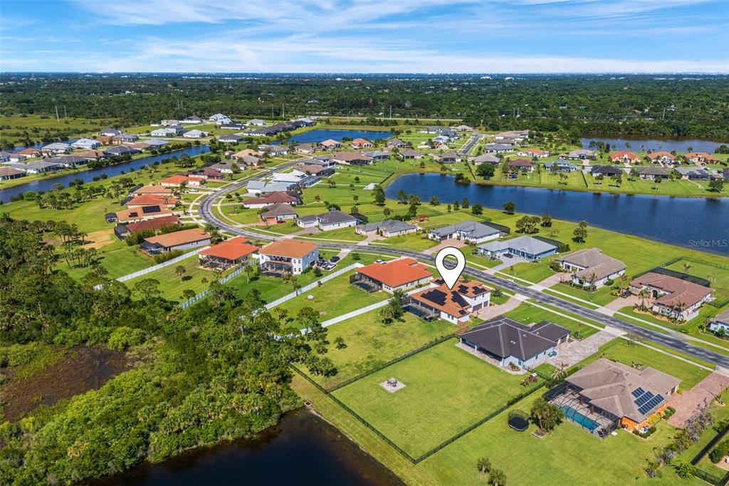 Aerial view of a residential neighborhood featuring houses with large yards and nearby ponds — 3897 PROVINCE DRIVE, MELBOURNE, FL