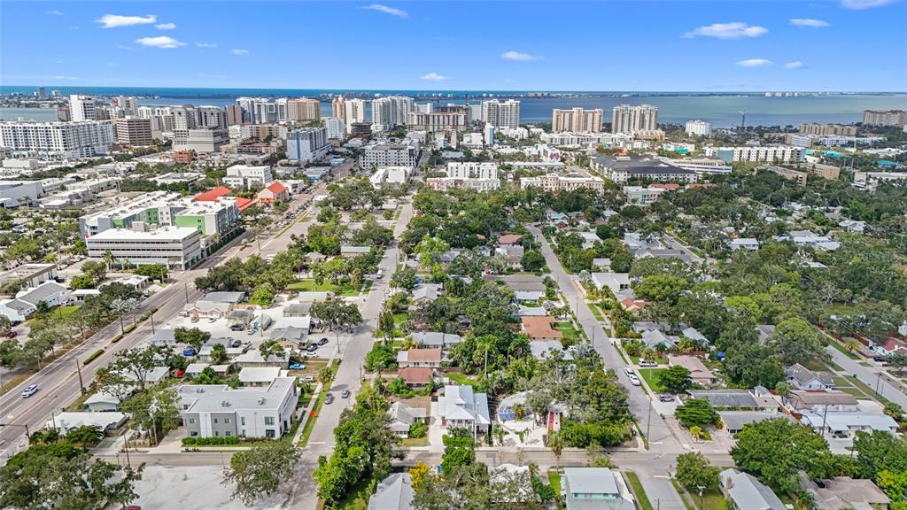 An aerial view shows a coastal city with residential neighborhoods, streets, and high-rise buildings — 417 N OSPREY AVENUE, SARASOTA, FL