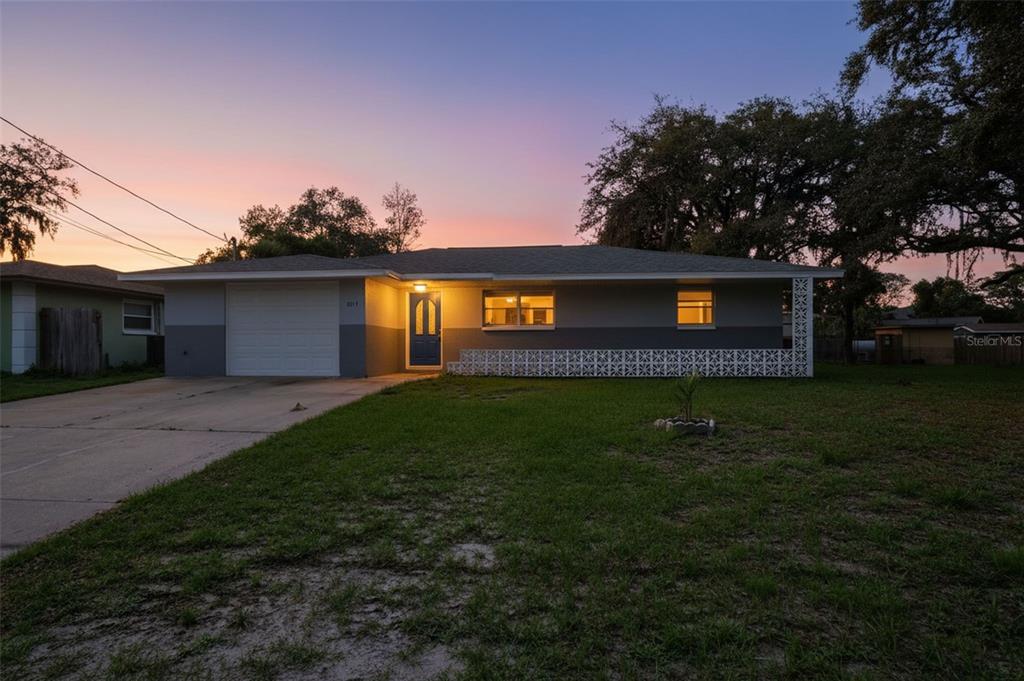 A single-story house with a two-tone gray exterior, a garage, and decorative concrete blocks — 8317 LIMAN DRIVE, NEW PORT RICHEY, FL