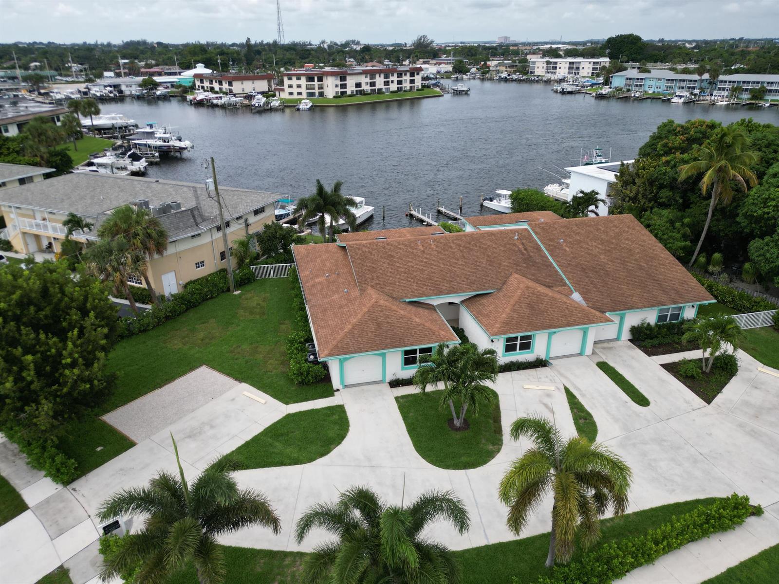 An aerial view shows a house with a brown roof and a large concrete driveway — 620 Southwind Circle # A, North Palm Beach FL 33408, NORTH PALM BEACH, FL