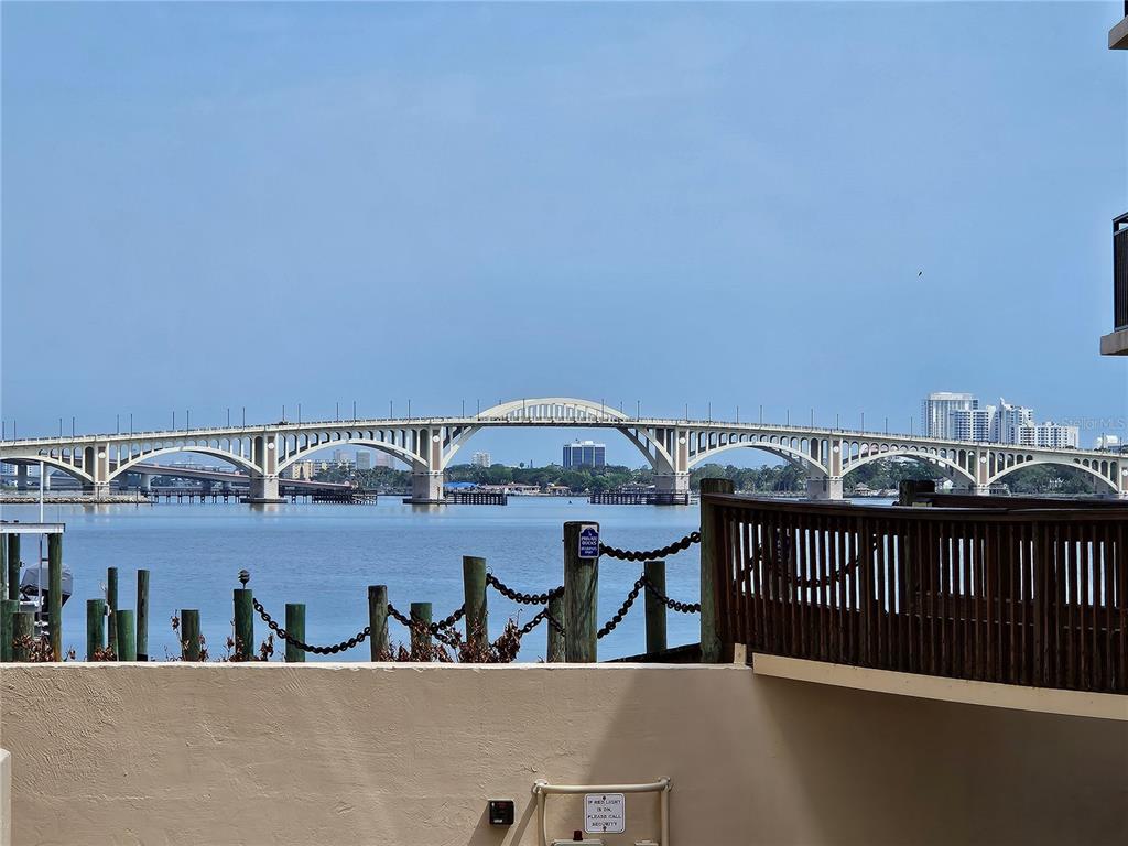 A view of a large concrete bridge over water from a balcony with wooden railings — 632 MARINA POINT DRIVE UNIT 6320, DAYTONA BEACH, FL