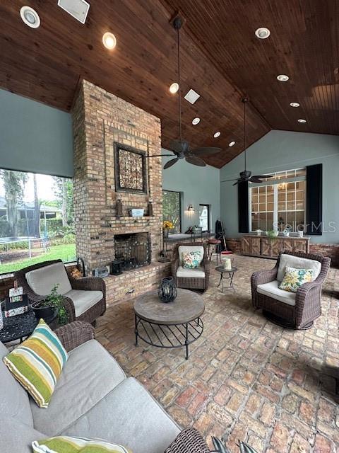 A screened-in patio features a swimming pool, brick columns, and an outdoor fireplace area — 34317 WINDLEY CIRCLE, EUSTIS, FL