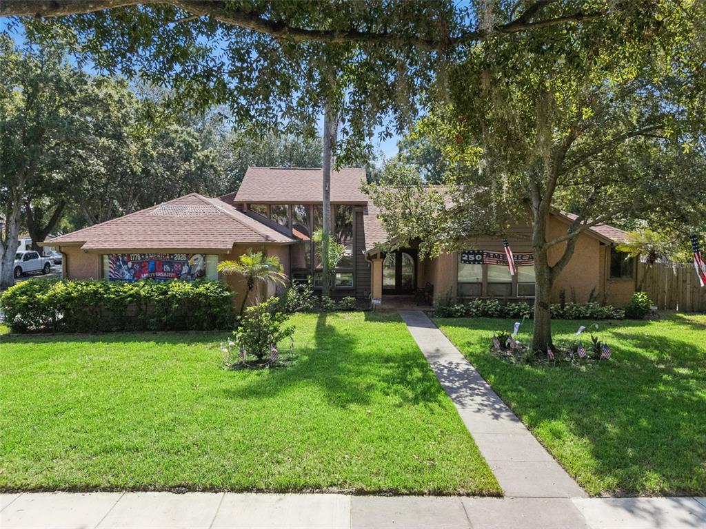 A single-story house with a brown roof, tan siding, and a front walkway — 5405 BAYBROOK AVENUE, ORLANDO, FL