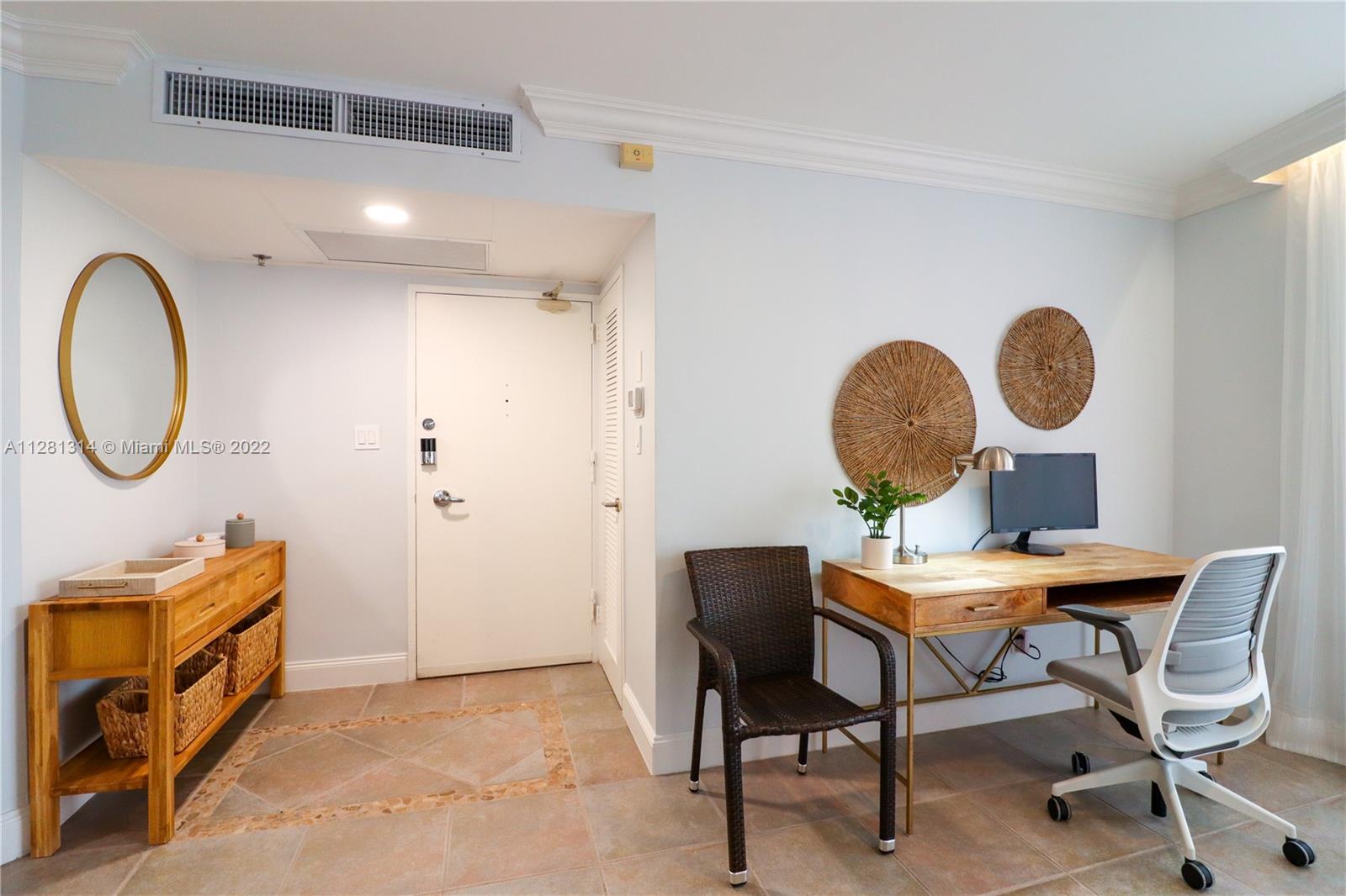 This room features a desk, a chair, a console table, and an entryway door — 5161 Collins Ave # 404, Miami Beach FL 33140, MIAMI BEACH, FL