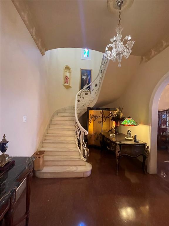 A grand foyer features a curved marble staircase with an ornate white railing and chandelier — 1404 VILA MAYO, SAN JUAN, PR