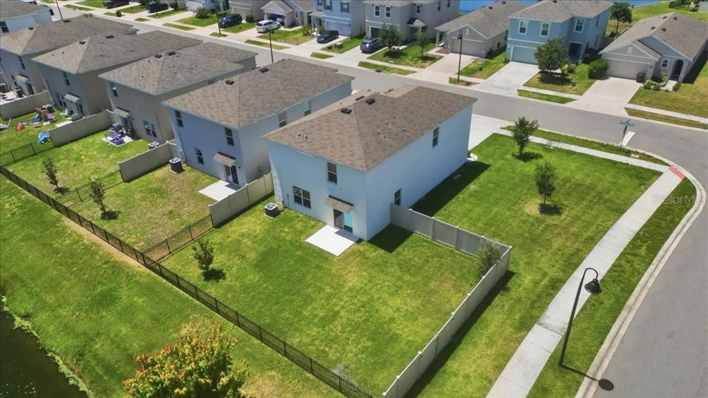 An aerial view shows a two-story house with a fenced backyard and a corner lot — 3126 SUNCOAST BLEND DRIVE, ODESSA, FL