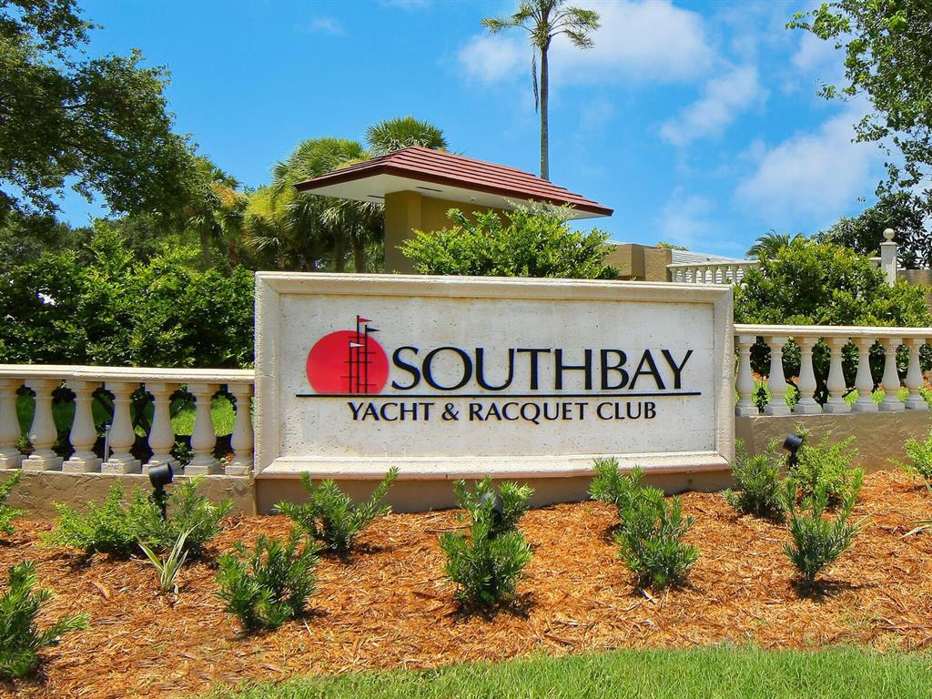 A stone sign for Southbay Yacht & Racquet Club stands in front of lush landscaping — 1355 SOUTHBAY DRIVE, OSPREY, FL