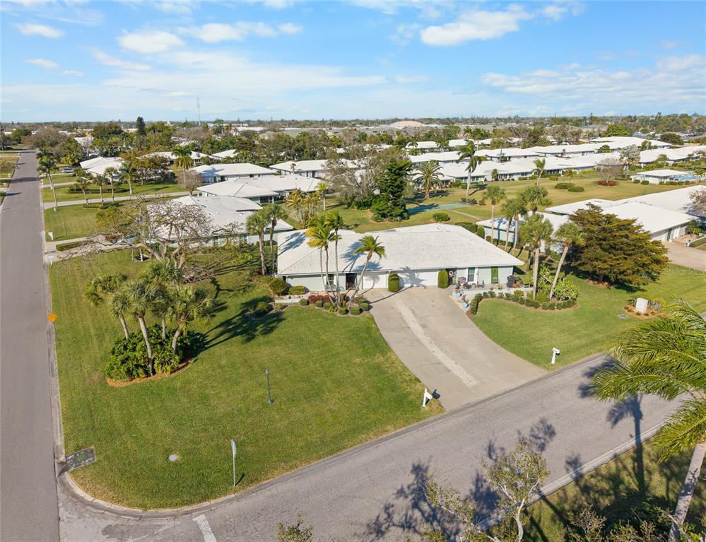 An aerial view shows a single-story house with a white roof and a concrete driveway — 6712 11TH AVENUE W UNIT 5601, BRADENTON, FL