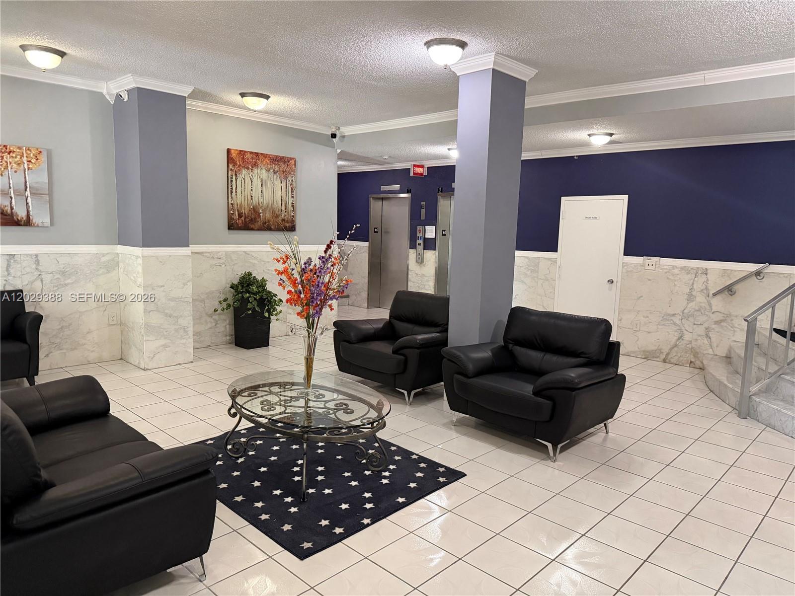 A lobby features black leather seating, a glass coffee table, and marble wainscoting — 501 E Dania Beach Blvd # 4D, Dania Beach FL 33004, DANIA BEACH, FL
