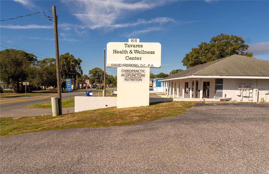 A sign for a health and wellness center stands in front of a single-story building — 915 E ALFRED STREET, TAVARES, FL