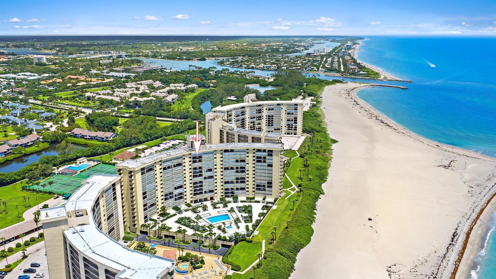 An aerial view shows a large beachfront condominium complex with a pool and tennis courts — 200 Ocean Trail Way # 1205, Jupiter FL 33477, JUPITER, FL