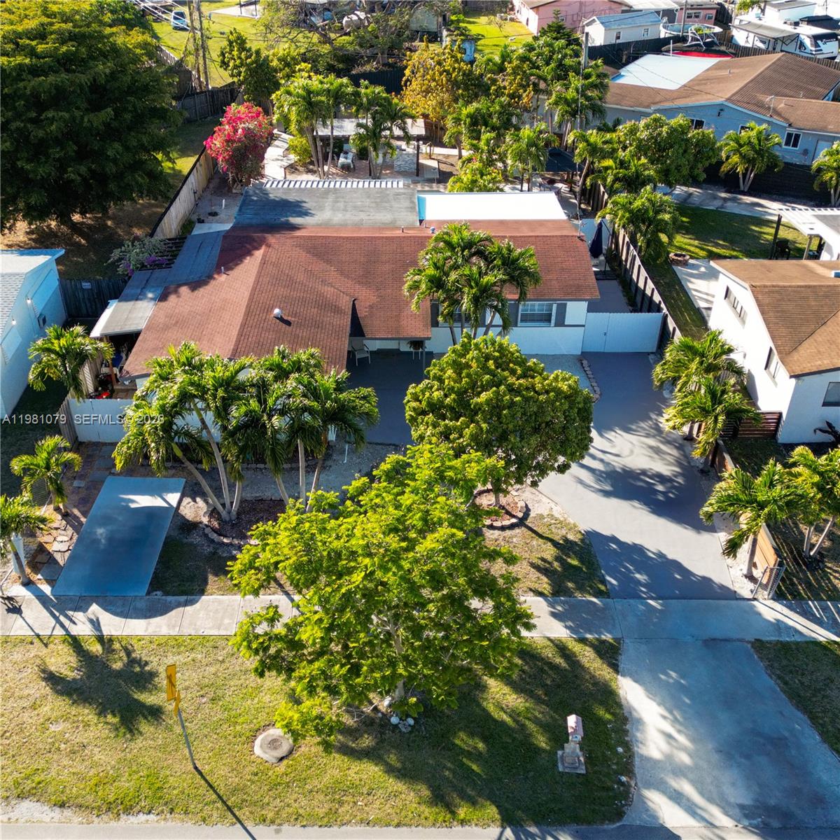 An aerial view shows a single-story house with a brown roof and surrounding palm trees — 19600 Gulfstream Rd, Cutler Bay FL 33157, CUTLER BAY, FL
