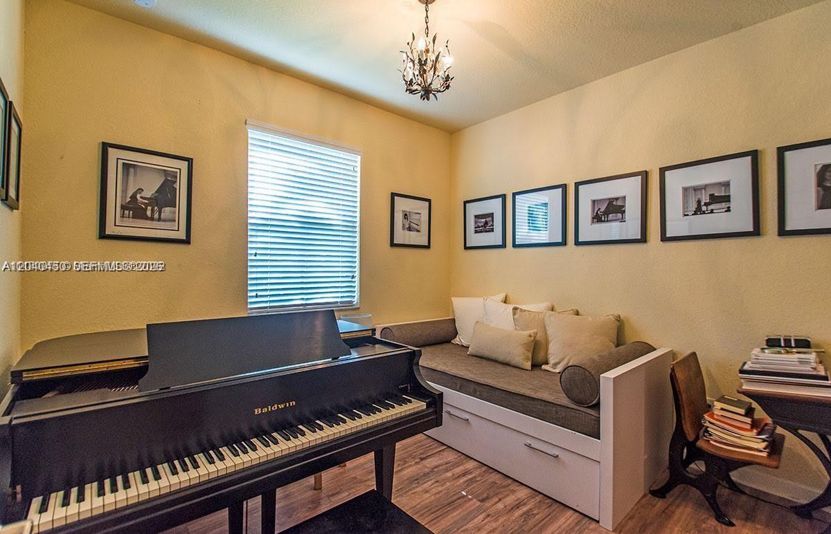 A room with a Baldwin grand piano, a daybed, and framed wall art — 1522 SW 144th Ave, Miami FL 33184, MIAMI, FL