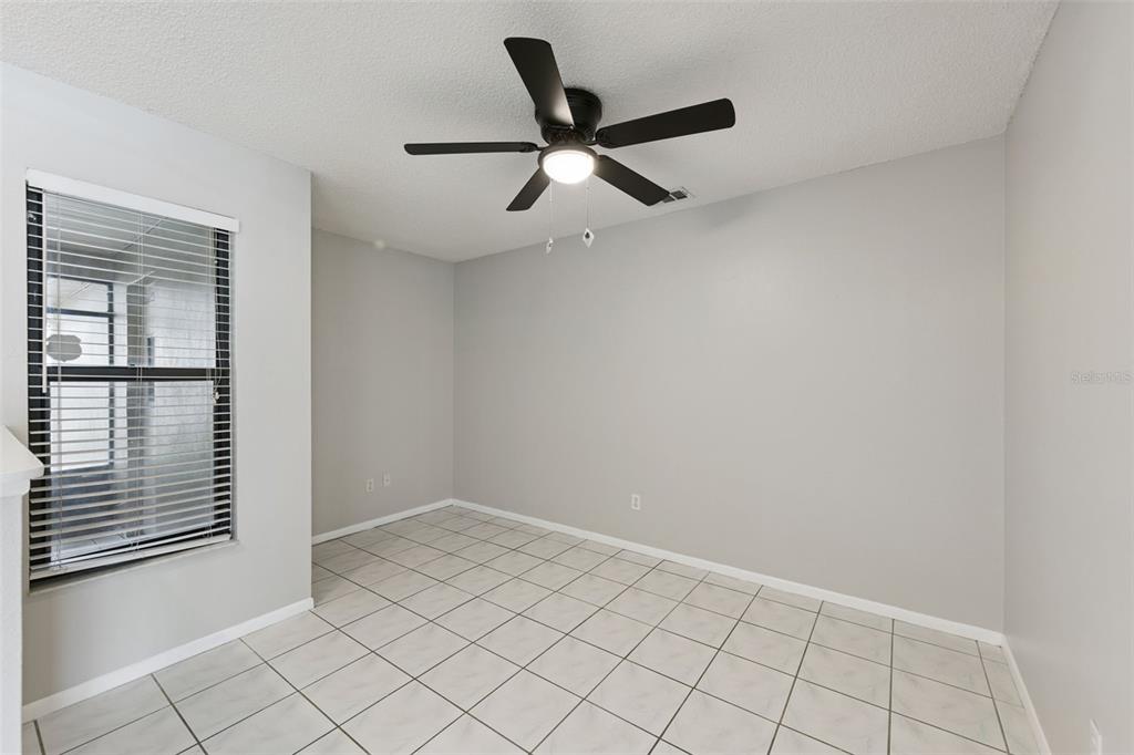 A room with light gray walls, white tile flooring, and a ceiling fan — 1008 OLLIFF WAY, OVIEDO, FL