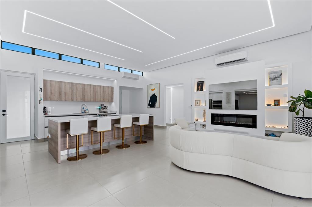 A modern open-concept kitchen and living area featuring white tile floors and recessed lighting — 96 CALLE AMAZONAS, BAYAMON, PR