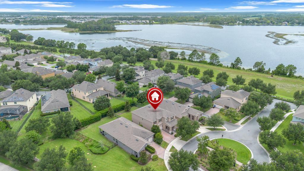 An aerial view shows a suburban neighborhood with houses, a cul-de-sac, and a large lake — 15512 FOUNTAIN COVE COURT, WINTER GARDEN, FL